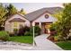 Charming home with a brick facade, inviting walkway, manicured lawn, and mature landscaping at 3231 Oak St, Wheat Ridge, CO 80033