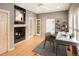 Home office with fireplace, built-in shelving, and hardwood floors at 3231 Oak St, Wheat Ridge, CO 80033