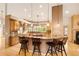 A gourmet kitchen features wood cabinets, granite countertops, and bar stool seating at the kitchen island at 3231 Oak St, Wheat Ridge, CO 80033