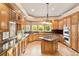 A large gourmet kitchen offers stainless steel appliances, wood cabinets, and granite countertops with ample workspace at 3231 Oak St, Wheat Ridge, CO 80033