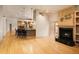 Open floor plan featuring a fireplace, hardwood floors, and a breakfast bar at 3231 Oak St, Wheat Ridge, CO 80033