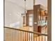 Bright, open-concept living area with hardwood floors, chandelier, and access to the kitchen and other rooms at 3231 Oak St, Wheat Ridge, CO 80033