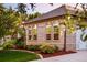 Brick exterior with arched windows, lush landscaping, and a well-maintained lawn at 3231 Oak St, Wheat Ridge, CO 80033