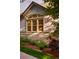 Exterior view of window with beautiful stonework and well maintained landscaping in this charming home at 3231 Oak St, Wheat Ridge, CO 80033