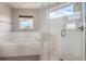 Modern bathroom with a soaking tub, glass enclosed shower, and bright light at 4457 Wyandot St, Denver, CO 80211