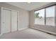 Bedroom with carpet, light walls, one window, and a closet with sliding doors at 4457 Wyandot St, Denver, CO 80211
