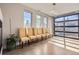 Sunlit dining room with six chairs, hardwood floors, and modern lighting at 4457 Wyandot St, Denver, CO 80211