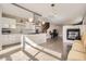 Open kitchen and dining area with island, modern hood, stainless appliances, and fireplace at 4457 Wyandot St, Denver, CO 80211