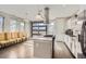 Bright, open kitchen with granite island, modern hood vent, and view of outdoor garage door at 4457 Wyandot St, Denver, CO 80211