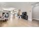 Bright living room features hardwood floors, a modern fireplace, and an open layout to the kitchen at 4457 Wyandot St, Denver, CO 80211