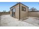 Exterior image of the rooftop deck, featuring a sliding glass door and neutral colored siding at 4457 Wyandot St, Denver, CO 80211