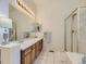 Bathroom with double sinks, vanity, and separate shower and tub at 17284 E Hawksbead Dr, Parker, CO 80134