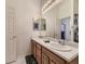 Bathroom with double sink vanity, a large mirror, and white tiling at 17284 E Hawksbead Dr, Parker, CO 80134