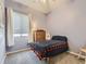 Bright bedroom with a bed, wood dresser, neutral walls, and carpeted floors at 17284 E Hawksbead Dr, Parker, CO 80134