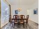 Dining room featuring a wooden table with six chairs under a chandelier, and gray carpet at 17284 E Hawksbead Dr, Parker, CO 80134