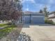 Charming single-Gathering home with a two-car garage, landscaped front yard, and a blue exterior at 17284 E Hawksbead Dr, Parker, CO 80134