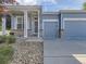 Charming blue home with a well-manicured front yard, featuring a two-car garage at 17284 E Hawksbead Dr, Parker, CO 80134