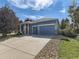 Charming single-Gathering home featuring a two-car garage, landscaped front yard, and inviting curb appeal at 17284 E Hawksbead Dr, Parker, CO 80134