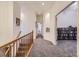 Upstairs hallway showcasing open doorway and carpet flooring at 17284 E Hawksbead Dr, Parker, CO 80134