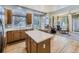 Open kitchen with wood cabinets, large island, and breakfast nook filled with natural light at 17284 E Hawksbead Dr, Parker, CO 80134