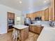 Well-lit kitchen with wood cabinets, stainless appliances, and a functional island at 17284 E Hawksbead Dr, Parker, CO 80134