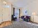 Traditional living room with carpet, a large window, a sofa, and a chandelier at 17284 E Hawksbead Dr, Parker, CO 80134
