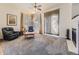 Cozy living room featuring neutral carpet, a ceiling fan and large windows with curtains at 17284 E Hawksbead Dr, Parker, CO 80134