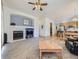 Comfortable living room with fireplace and seamless transition to the eat-in kitchen at 17284 E Hawksbead Dr, Parker, CO 80134