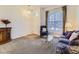 Cozy living room featuring neutral carpet, a window, and classic furniture arrangement at 17284 E Hawksbead Dr, Parker, CO 80134