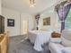 Bright main bedroom with plush carpet, large windows, and a cozy sitting area at 17284 E Hawksbead Dr, Parker, CO 80134