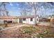 Backyard featuring a detached garage, driveway and landscaping at 2933 Benton St, Wheat Ridge, CO 80214