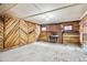 Spacious basement with a brick fireplace and wood paneled walls at 2933 Benton St, Wheat Ridge, CO 80214