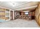 Basement with a stone wall, bar and wood paneled accents at 2933 Benton St, Wheat Ridge, CO 80214