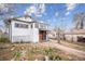 Exterior side view of a home with a wooden front door at 2933 Benton St, Wheat Ridge, CO 80214