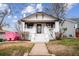 Charming home with white exterior, gray trim, landscaped yard and front yard sidewalk leading to the entrance at 2933 Benton St, Wheat Ridge, CO 80214