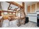 Rustic kitchen with brick accents, wooden cabinets, and tile flooring, creating a warm and inviting culinary space at 2933 Benton St, Wheat Ridge, CO 80214