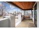 Inviting covered porch with a swing, wood ceiling, and pillars, creating a cozy outdoor seating area at 2933 Benton St, Wheat Ridge, CO 80214