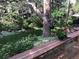 Beautiful backyard with mature trees, flowers and outdoor seating area on wood deck at 19850 Indian Summer Ln, Monument, CO 80132