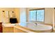 Relaxing bathroom with a large soaking tub and serene window view, perfect for unwinding at 19850 Indian Summer Ln, Monument, CO 80132
