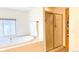 Bright bathroom with a soaking tub and glass shower, offering a spa-like experience at 19850 Indian Summer Ln, Monument, CO 80132