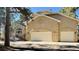 Charming home features a stucco facade, two-car garage, and well-manicured front yard at 19850 Indian Summer Ln, Monument, CO 80132
