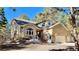 Beautifully landscaped two-story home with a large arched window and attached two-car garage at 19850 Indian Summer Ln, Monument, CO 80132
