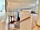 Bright, two-story foyer with a beautiful chandelier, wooden front door, and staircase with wrought iron railings at 19850 Indian Summer Ln, Monument, CO 80132