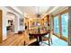 Open kitchen/dining area featuring wood floors, cabinets and a view to another room through an archway at 19850 Indian Summer Ln, Monument, CO 80132