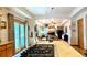 Bright kitchen with an island cooktop and an open view to the dining and living areas at 19850 Indian Summer Ln, Monument, CO 80132