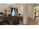 Cozy living room showcasing neutral carpet, decor, a comfortable sofa, and a view into the dining room at 19850 Indian Summer Ln, Monument, CO 80132