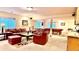 A spacious living room is furnished with leather sofas, a pool table, and lots of light at 19850 Indian Summer Ln, Monument, CO 80132
