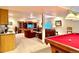 Expansive living room with a wet bar, pool table, and comfortable seating at 19850 Indian Summer Ln, Monument, CO 80132
