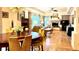 Open-concept living area boasts a fireplace, wood floors, and large windows offering ample natural light at 19850 Indian Summer Ln, Monument, CO 80132