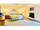 Cozy main bedroom with ceiling fan, fireplace, and comfortable furnishings at 19850 Indian Summer Ln, Monument, CO 80132